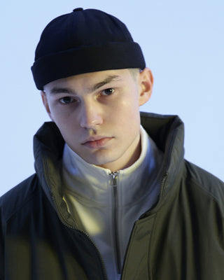 Group of friends wearing brimless caps on a camping trip