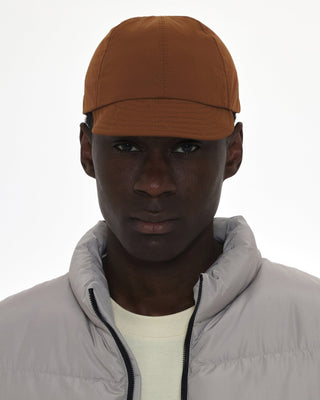 Foldable ball cap displayed on a backpack