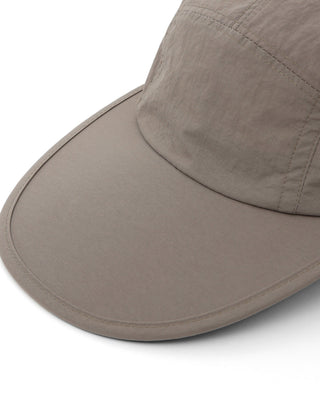 Flat visor cap worn during a sunny day.