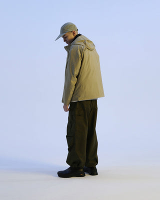 Flat visor cap worn during a sunny day.