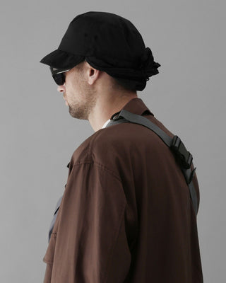 Safari hat alongside binoculars, emphasizing exploration readiness.