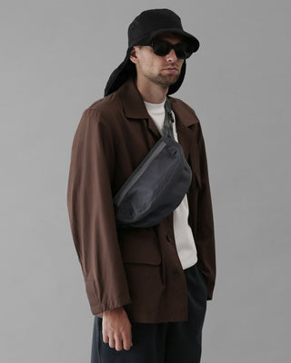 Earflap hat combined with summer accessories for a casual look.