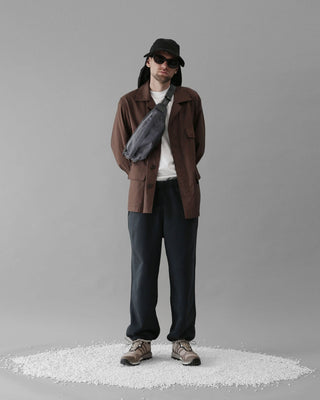 A person using a foldable visor during a sunny day outdoors.