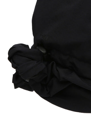 Earflap hat showcased in a summer landscape, highlighting its breezy design.