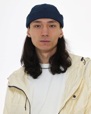 Watch cap in a cityscape setting