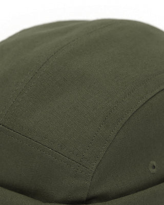 A watch cap worn by a cyclist on a forest trail.