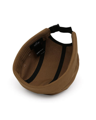 Watch caps in various colors laid out on a grassy field.