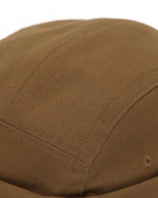 A watch cap with a nature-inspired pattern on a rock.