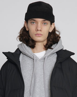 A close-up of a stylish watch cap in a neutral color.