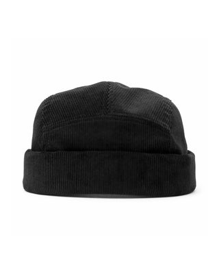 An outdoor Leon beanie being worn by a hiker on a mountain trail.