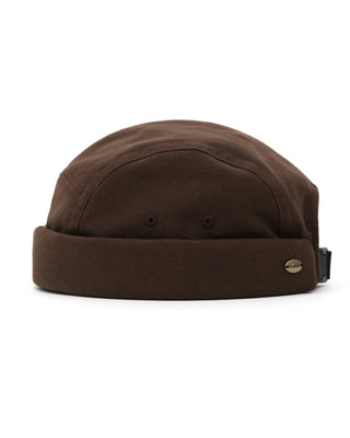 Model wearing UC brimless cap in brown