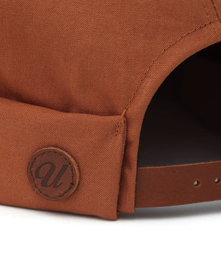 Brimless cap with an embroidered logo