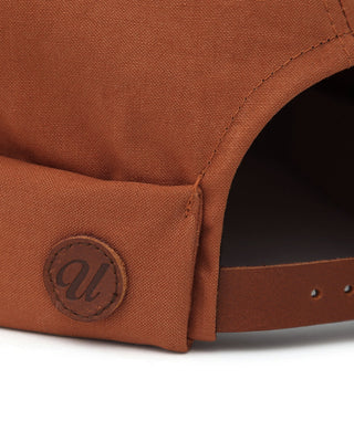 Brimless cap with an embroidered logo