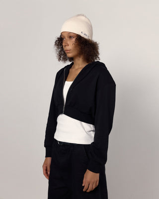 Beanie in a fall foliage background