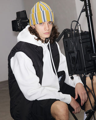 model-wearing-undercontrol-brand-yellow-color-vertical-stripe-knit-beanie-with-logo-photo