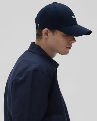 male-model-side-view-wearing-undercontrol-brand-navy-color-ball-cap-photo