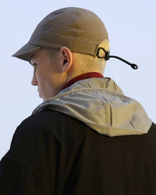 model-wearing-urh-brand-recycled-nylon-gray-color-flexible-visor-ball-cap-photo