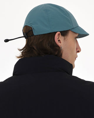 model-wearing-urh-brand-supplex-fabric-sky-color-flexible-visor-ball-cap-photo