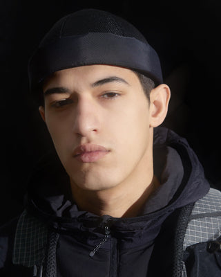 model-wearing-urh-brand-supplex-mesh-brimless-cap-photo