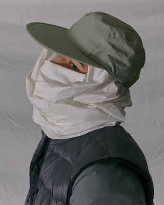 Flat visor cap laid out with other outdoor gear.